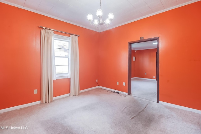 carpeted spare room with ornamental molding and a chandelier