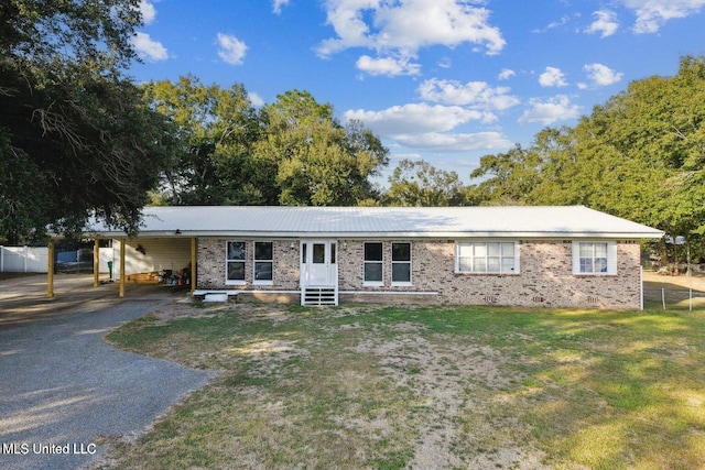 ranch-style home featuring a front yard and a carport