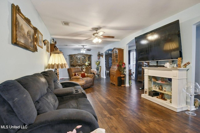 living room featuring ceiling fan and dark hardwood / wood-style flooring