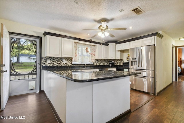 kitchen featuring white cabinetry, dark hardwood / wood-style flooring, stainless steel refrigerator with ice dispenser, kitchen peninsula, and a textured ceiling