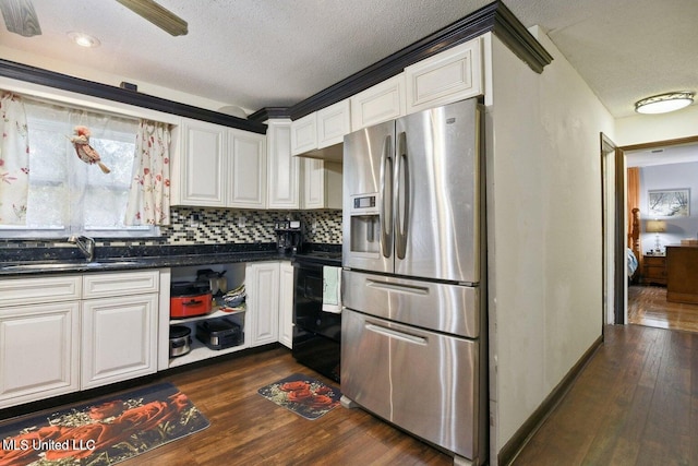 kitchen with white cabinets, black range, sink, stainless steel refrigerator with ice dispenser, and dark hardwood / wood-style flooring