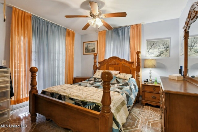 tiled bedroom featuring ceiling fan