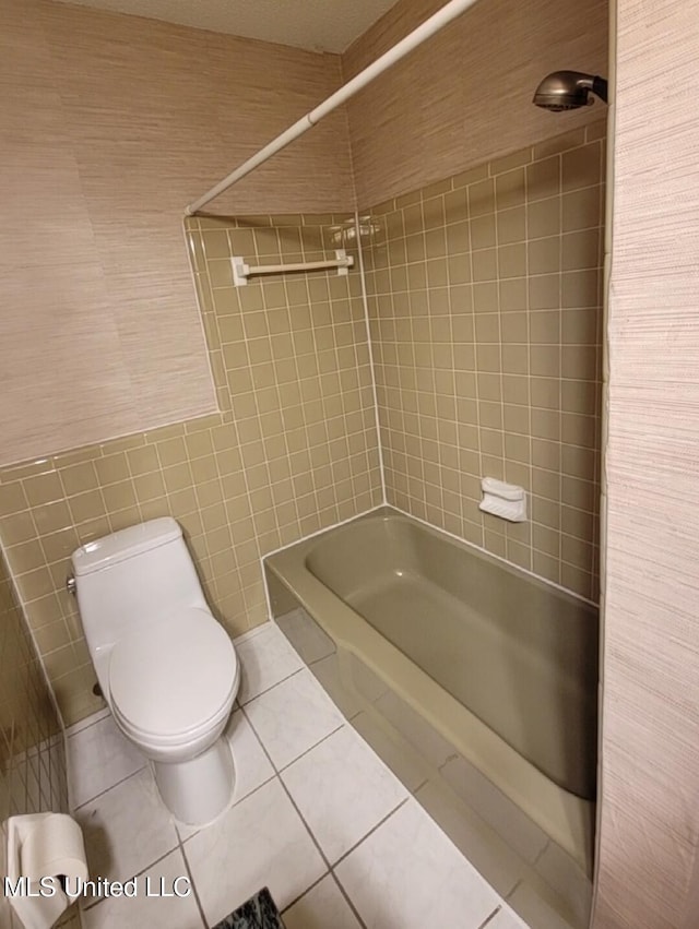 1704 Pat Dr, Gautier, MS 39553 - bathroom with tile walls, tile patterned flooring, shower / bathtub combination, and toilet