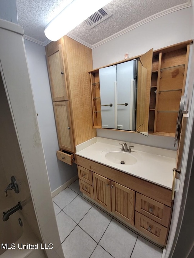 1704 Pat Dr, Gautier, MS 39553 - bathroom with crown molding, a textured ceiling, tile patterned floors, and visible vents