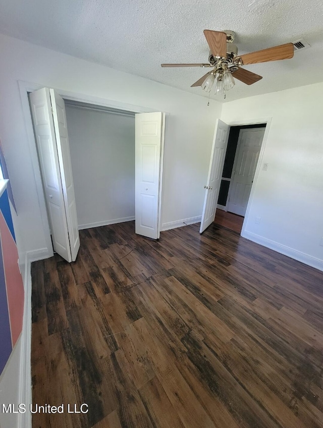 1704 Pat Dr, Gautier, MS 39553 - unfurnished bedroom featuring a textured ceiling, dark wood finished floors, baseboards, and visible vents