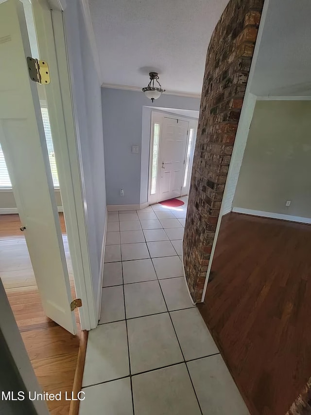1704 Pat Dr, Gautier, MS 39553 - corridor with baseboards, crown molding, and light tile patterned flooring