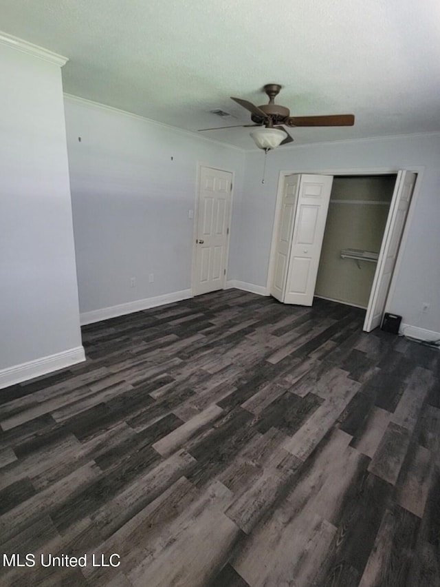 1704 Pat Dr, Gautier, MS 39553 - unfurnished bedroom featuring baseboards, ceiling fan, a closet, and dark wood-style floors