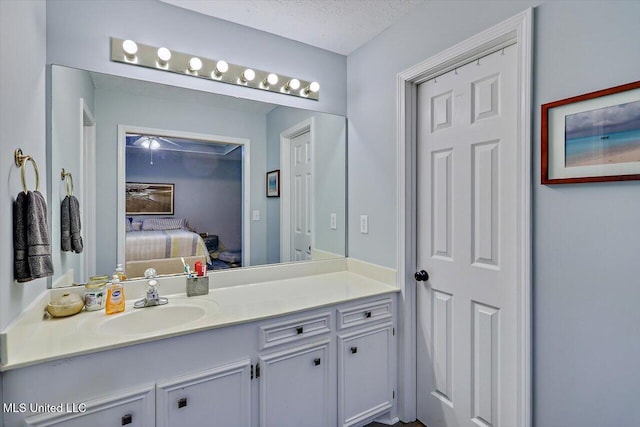 bathroom with vanity, ensuite bathroom, and a ceiling fan