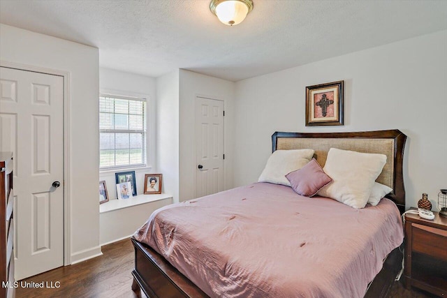 bedroom featuring baseboards and dark wood-style floors