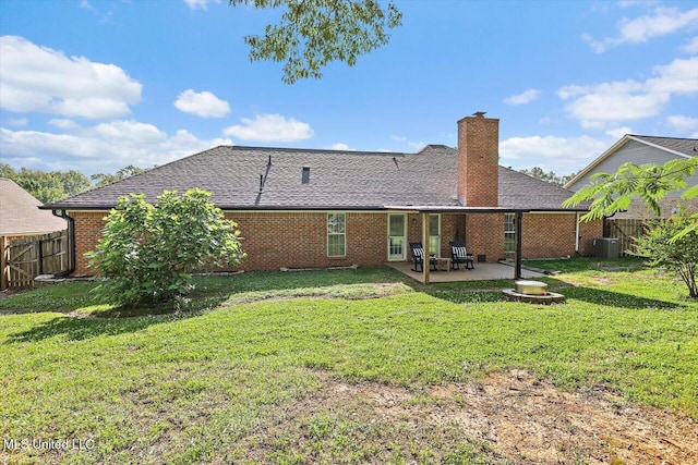 back of house with a yard, a patio, a chimney, and a fenced backyard