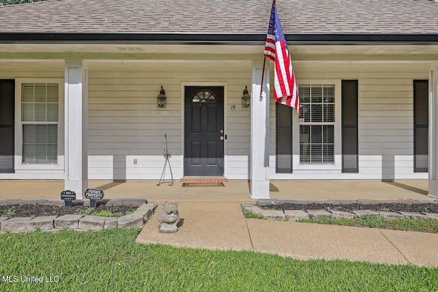 property entrance with a porch and a shingled roof