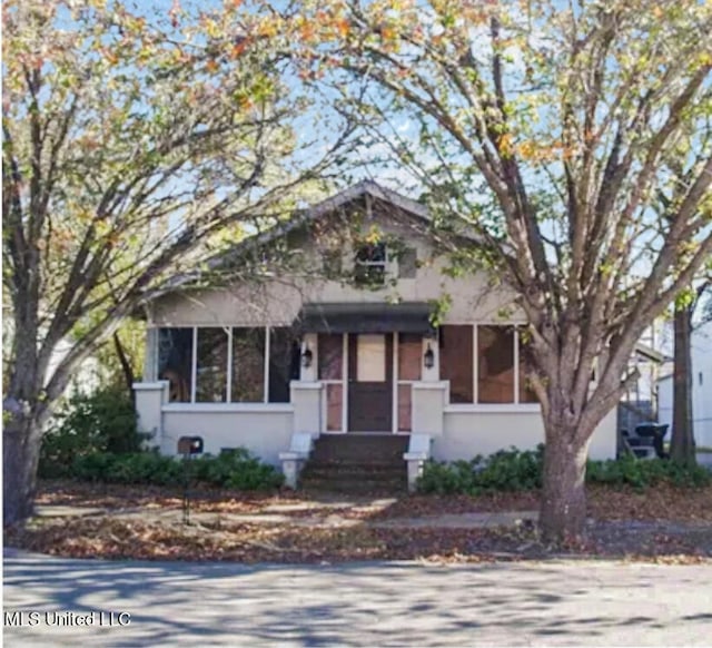 view of front of house featuring a sunroom