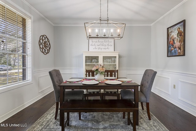 dining room featuring dark wood-style floors, wainscoting, and ornamental molding