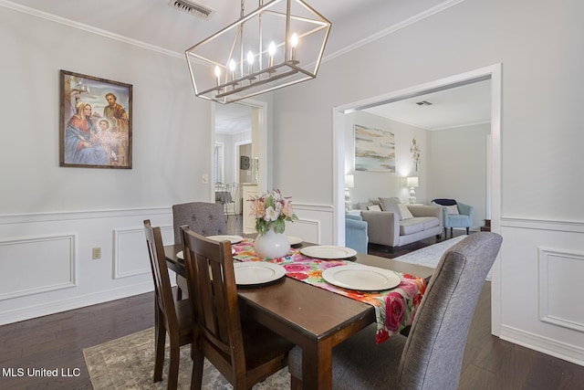 dining space featuring visible vents, dark wood-style floors, ornamental molding, and a decorative wall