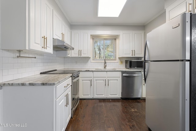 kitchen featuring dark wood-style floors, a sink, under cabinet range hood, appliances with stainless steel finishes, and white cabinetry