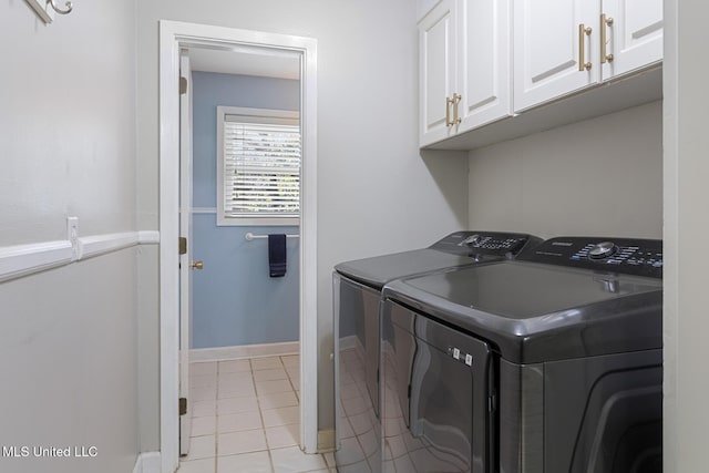 washroom featuring light tile patterned floors, cabinet space, independent washer and dryer, and baseboards