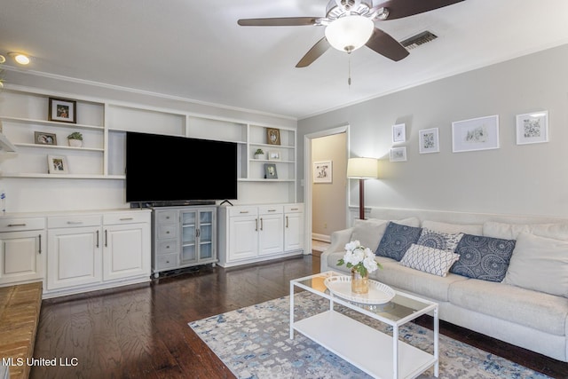 living area featuring visible vents, a ceiling fan, dark wood-style flooring, and crown molding