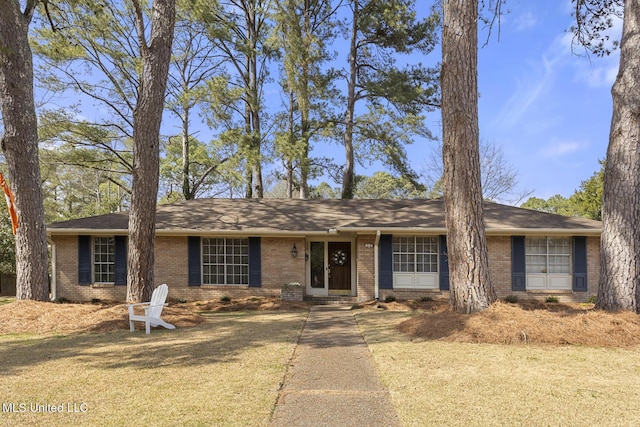 ranch-style home with brick siding and a front lawn