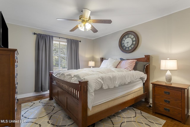 bedroom with crown molding, a ceiling fan, and baseboards