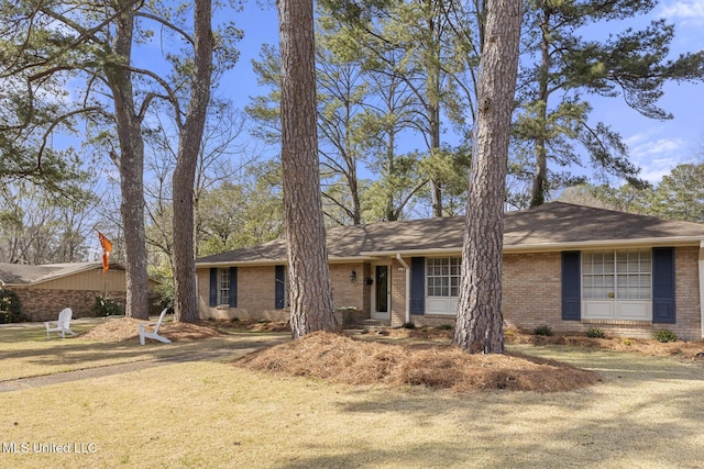 ranch-style home featuring brick siding