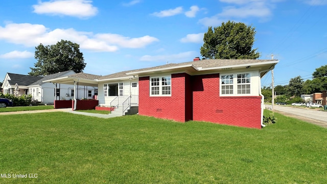 1049 Idlewild St, Memphis, TN 38107 - view of front facade with crawl space, a front lawn, and brick siding