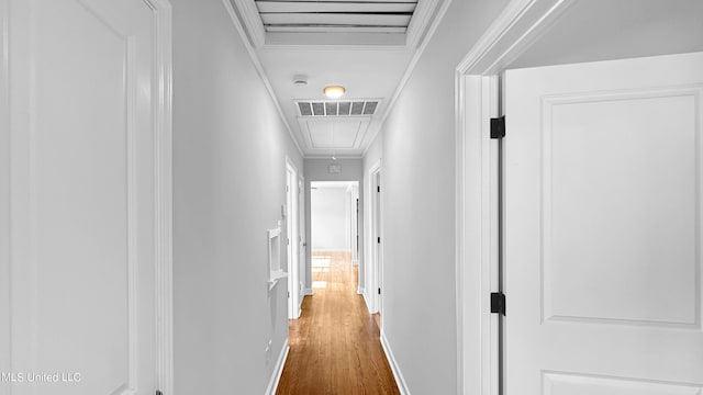 corridor with dark hardwood / wood-style flooring and ornamental molding