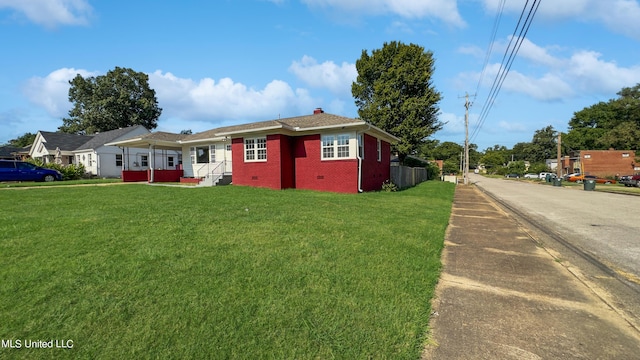 1049 Idlewild St, Memphis, TN 38107 - single story home with a chimney, a front lawn, and brick siding