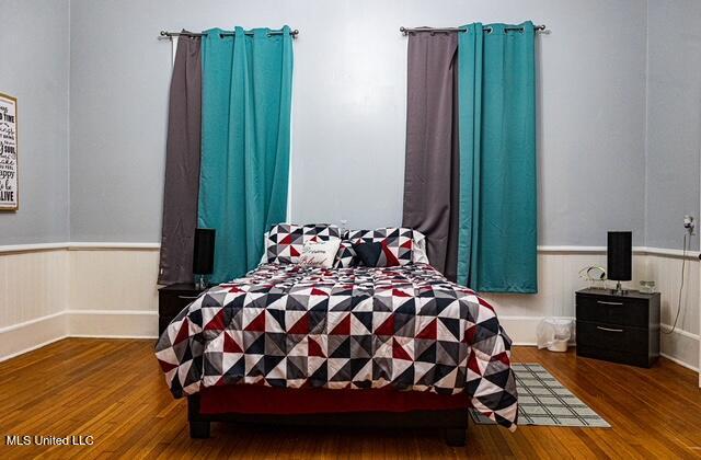 733 S College St, Grenada, MS 38901 - bedroom with wainscoting and wood finished floors