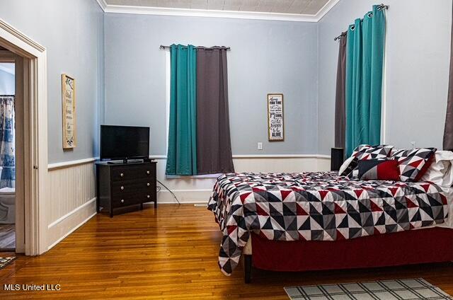 733 S College St, Grenada, MS 38901 - bedroom featuring wood finished floors and crown molding
