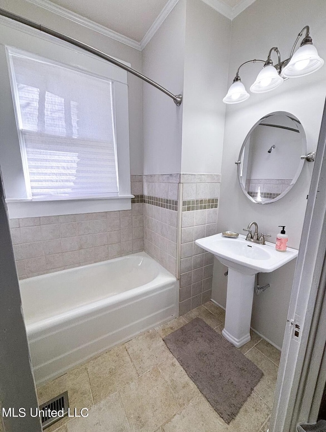 bathroom with shower / bath combination, tile walls, and ornamental molding