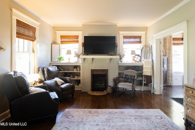 living room featuring dark hardwood / wood-style floors, a brick fireplace, and crown molding