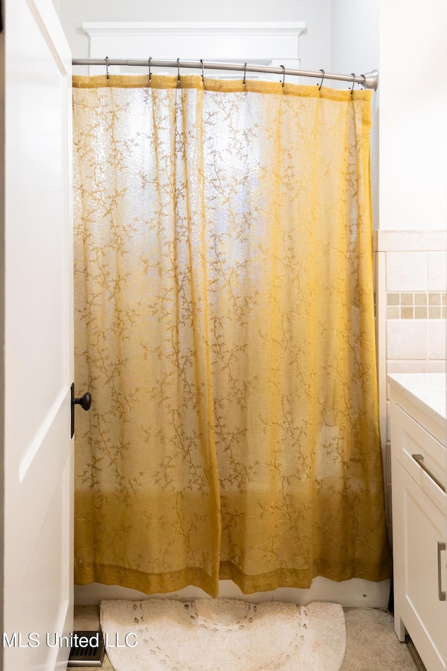 bathroom with vanity and tile walls