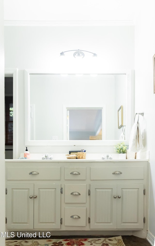 bathroom with vanity and ornamental molding