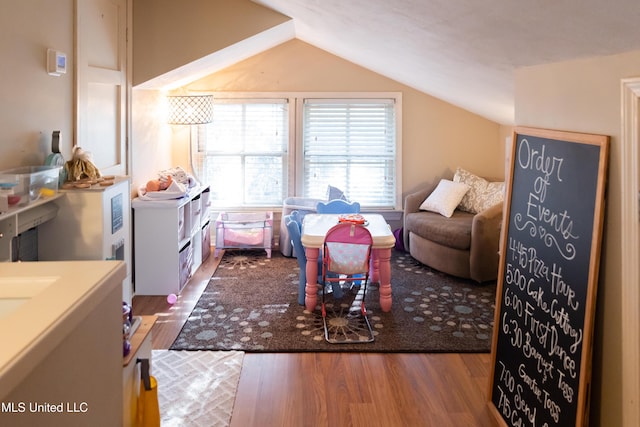 game room featuring hardwood / wood-style floors and vaulted ceiling