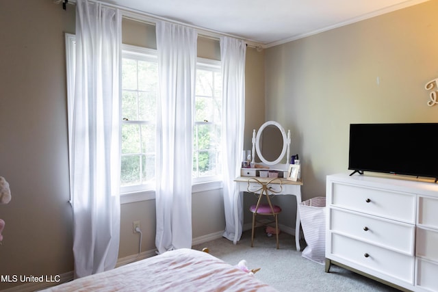 bedroom featuring multiple windows, crown molding, and light colored carpet