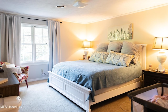 bedroom with carpet floors and crown molding