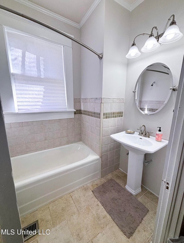 bathroom with tub / shower combination, ornamental molding, and tile walls