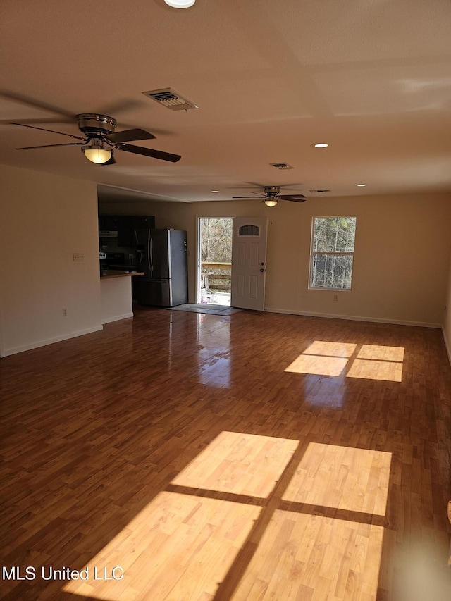 unfurnished room with ceiling fan and wood-type flooring