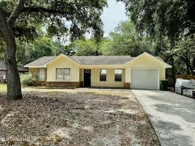 909 Orange St, Ocean Springs, MS 39564 - single story home featuring an attached garage, driveway, brick siding, and roof with shingles