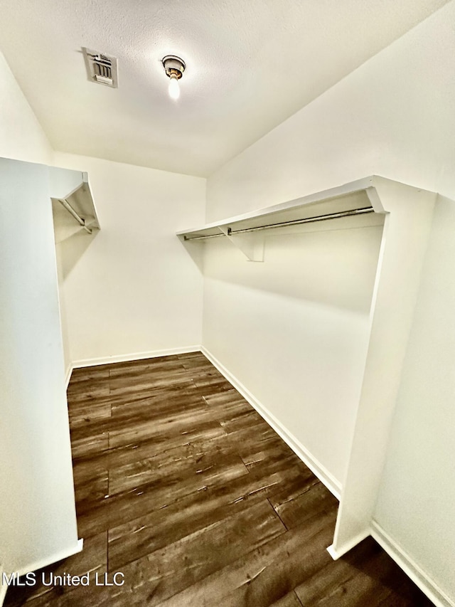 909 Orange St, Ocean Springs, MS 39564 - spacious closet featuring dark wood-type flooring