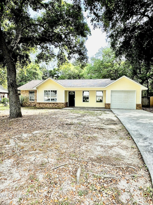 909 Orange St, Ocean Springs, MS 39564 - ranch-style house with driveway, a garage, and stone siding
