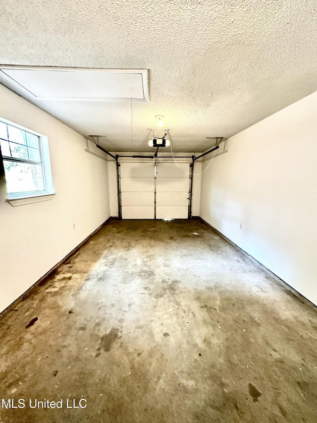 909 Orange St, Ocean Springs, MS 39564 - garage featuring a garage door opener and baseboards