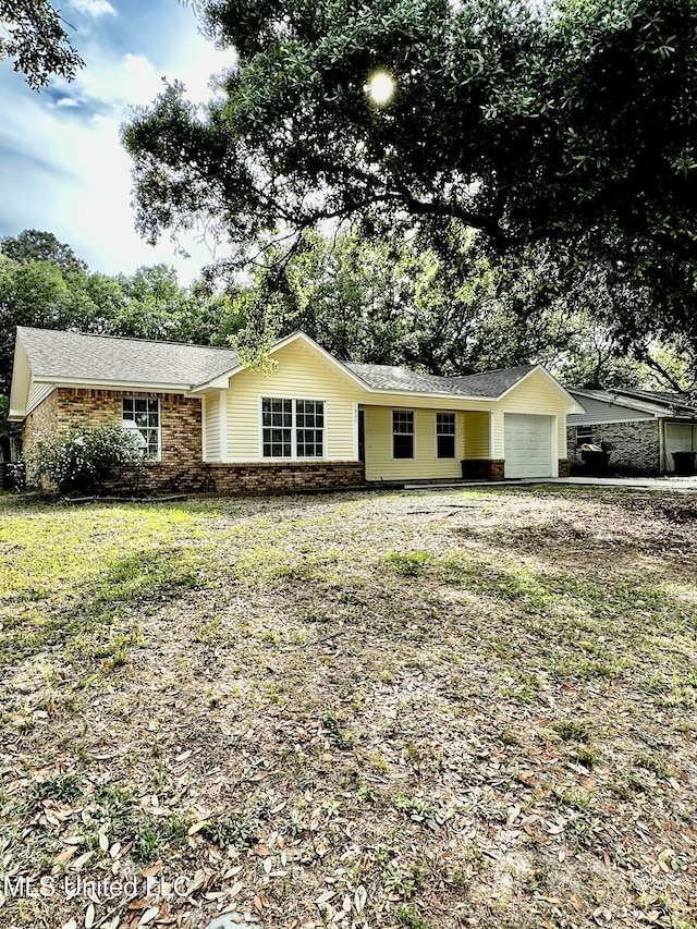 909 Orange St, Ocean Springs, MS 39564 - ranch-style house featuring an attached garage, brick siding, and a shingled roof