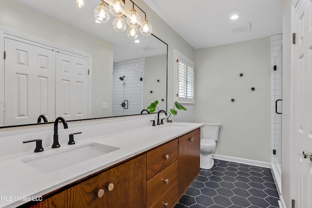 2123 Southwood Rd, Jackson, MS 39211 - full bathroom with double vanity, a shower stall, toilet, baseboards, and a chandelier