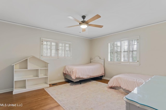 2123 Southwood Rd, Jackson, MS 39211 - bedroom featuring multiple windows, ornamental molding, wood finished floors, baseboards, and ceiling fan