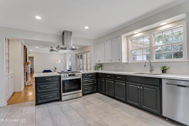 2123 Southwood Rd, Jackson, MS 39211 - kitchen featuring stainless steel appliances, a sink, exhaust hood, a peninsula, and healthy amount of natural light