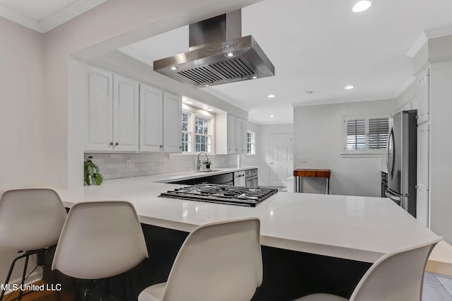 2123 Southwood Rd, Jackson, MS 39211 - kitchen featuring wall chimney exhaust hood, freestanding refrigerator, a sink, crown molding, and gas stovetop
