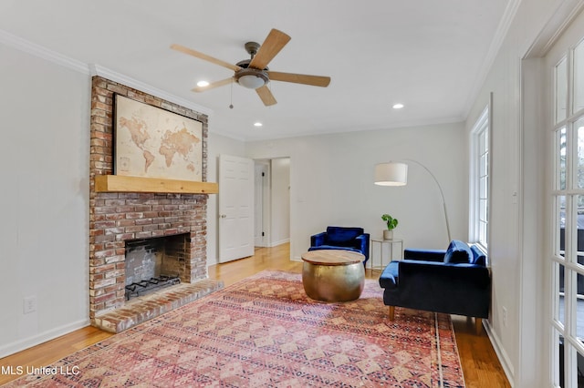 2123 Southwood Rd, Jackson, MS 39211 - living room featuring light wood-style flooring, crown molding, a ceiling fan, baseboards, and a fireplace