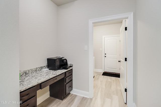 interior space featuring built in desk and light hardwood / wood-style floors