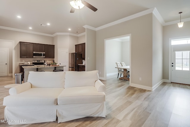 living room featuring ceiling fan, light hardwood / wood-style flooring, and ornamental molding